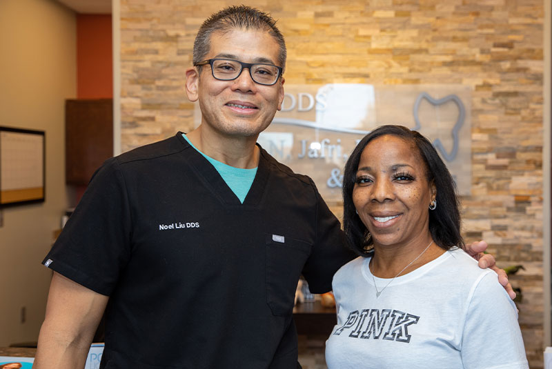 patient and doctor smiling within the dental center after procedure